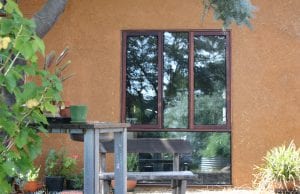 The majority of the straw bale home's timber frame, including the jarrah windows, are recycled wood.