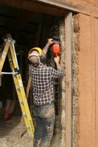 Shaping straw bales house walls with a chainsaw is standard practice but Joel Meadows found exhaust fumes are noxious.